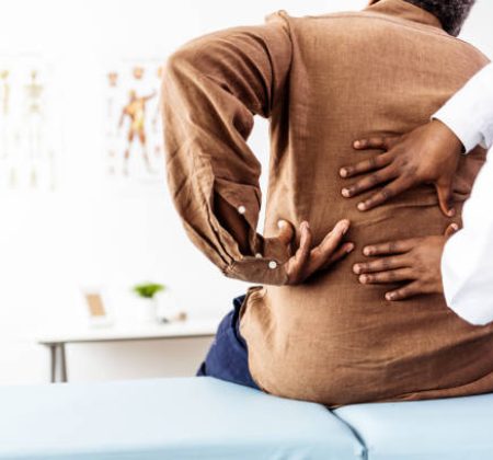 Doctor physiotherapist doing healing treatment on man's bac